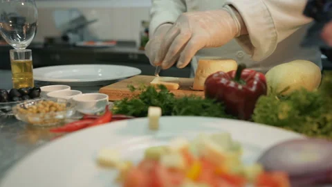 Shot of a piece of cheese on kitchen. Chef is cutting a piece of cheese on it wi Stock Footage 95142893
