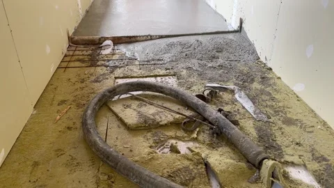 Shot of a pipe and concrete slab just poured. Expansion joint in the cement Stock Footage 320565182