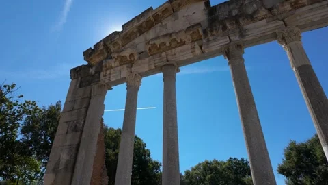 Shot of plane in blue sky going behind an ancient temple Stock Footage 347273689