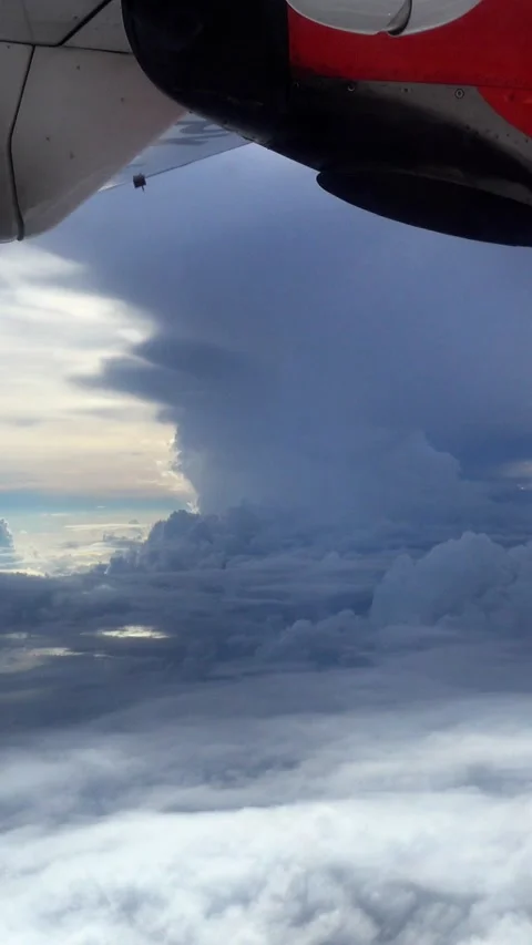 Shot of plane wing with clouds and sunlight going through 스톡 동영상 228827799