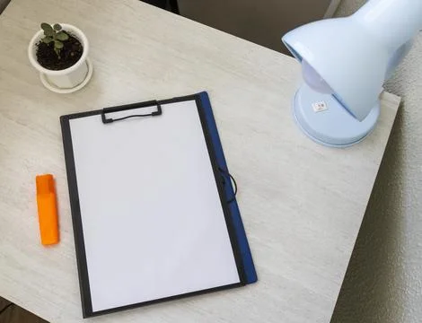 Shot of the plastic folder on the office desk with paper clip holder on the.. Stock Photos
