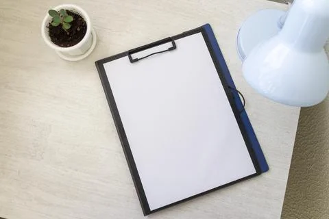 Shot of the plastic folder on the office desk with paper clip holder on the.. Foto stock