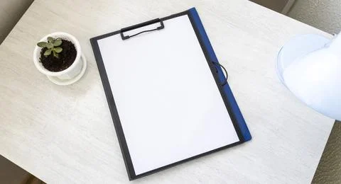Shot of the plastic folder on the office desk with paper clip holder on the.. Foto stock