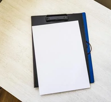 Shot of the plastic folder on the office desk with paper clip holder on the.. Stock Photos