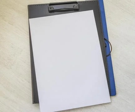 Shot of the plastic folder on the office desk with paper clip holder on the.. Stock Photos
