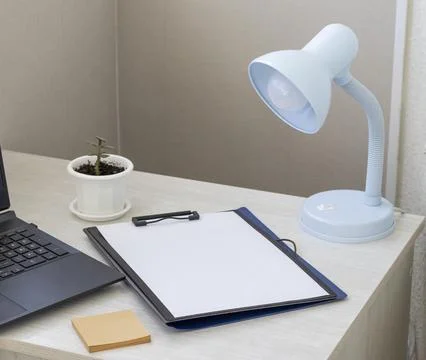 Shot of the plastic folder on the office desk with paper clip holder on the.. Stock Photos
