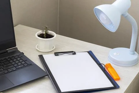 Shot of the plastic folder on the office desk with paper clip holder on the.. Stock Photos