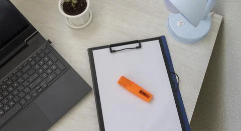 Shot of the plastic folder on the office desk with paper clip holder on the.. Stock Photos