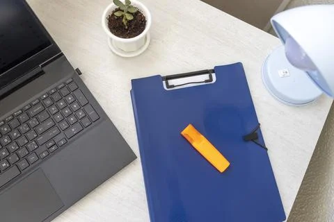 Shot of the plastic folder on the office desk with paper clip holder on the.. Stock Photos