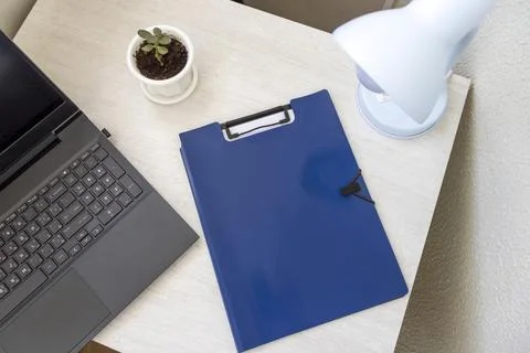 Shot of the plastic folder on the office desk with paper clip holder on the.. Stock Photos