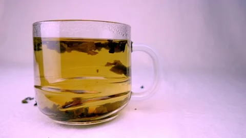 Shot of pouring tea on white background in glass cup Stock Footage 197008126
