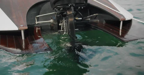 A shot of a powerful outboard engine starting, creating a splash of water. Stock Footage 269879771