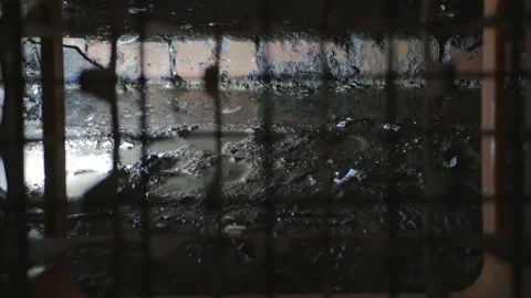 A shot from a prison cell through the bars on drops of water dripping from the Video stock 142707667