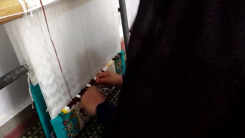 Shot of the process of weaving a carpet showcasing, stock footage. Stock Footage 304829499