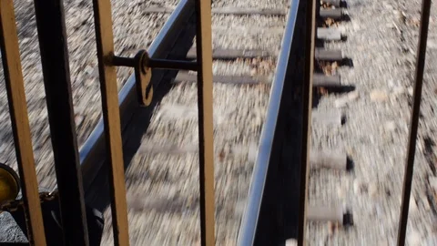 Shot of the railroad track inside a moving passenger train Stock Footage
