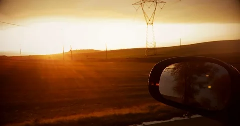 Shot on a rear view mirror of a sunset with nature in background Stock Footage 105881492