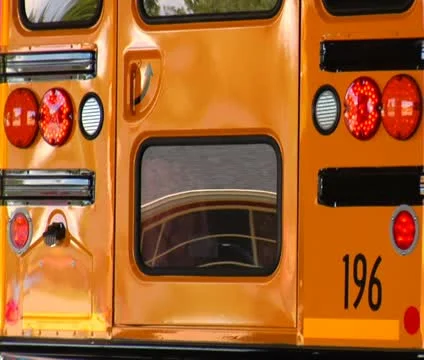 Shot of reflections in rear of parked schoolbus Stock Footage 21624413