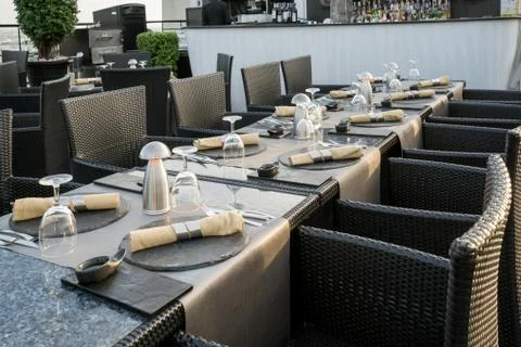 Shot of a restaurant table with empty glasses and a plate with a napkin on to Stock Photos