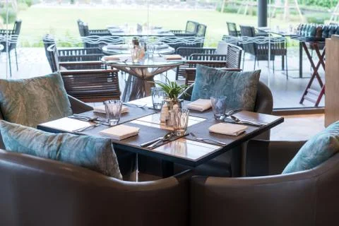 Shot of a restaurant table with empty glasses and a plate with a napkin in re Stock Photos