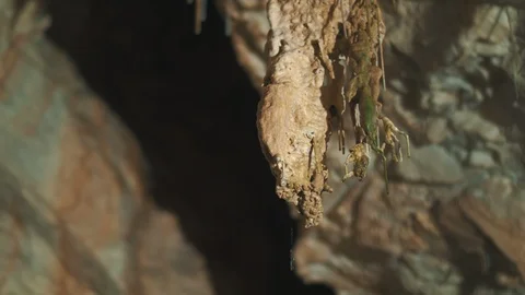 Shot of a rock formation inside a cave dripping water Stock Footage 94957814