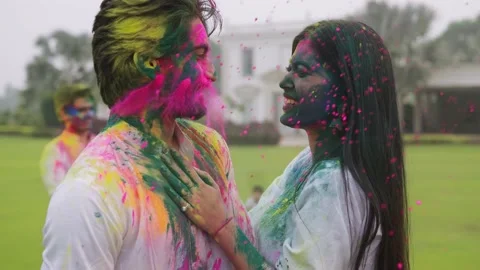 A shot of a romantic and affectionate couple is applying Holi colours Stock Footage 146718958