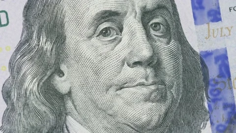 Shot of the rotating Benjamin Franklin's face on the 100 hundred dollar bill Stock Footage 165286638