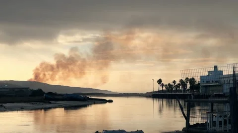 Shot of Rural Field Fire with Distant City Stock Footage 321038330
