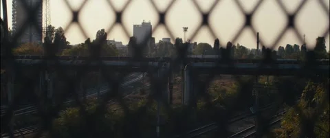 Shot of a safety net overlooking train tracks in the city during sunset. Stock Footage 252265958