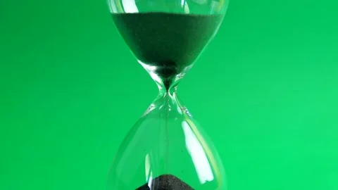 Shot of a sand clock measuring time while the sand is falling down against Stock Footage 137436767