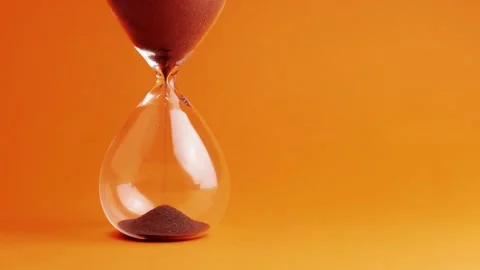 Shot of a sand clock measuring time while the sand is falling down Stock Footage 137436948