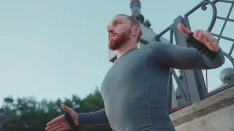 Shot of serious young man exercising with trx suspension strap near lake Stock Footage 138652979