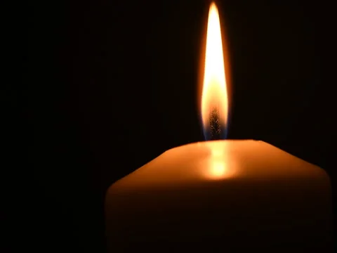 Shot of a single candle burning, isolated on black background. Stock Footage