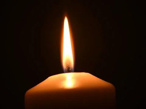 Shot of a single candle burning, isolated on black background Stock Footage 74793620