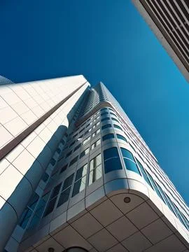 Shot of a skyscraper with round architectural features taken from bottom to.. 스톡 사진