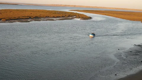 Shot of a small boat sailing through the Naila lagoon Stock Footage 245638465