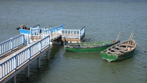 Shot of small boats that are docked in the port of Naila lagoon Stock Footage 245638522