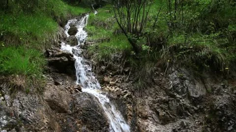 Shot of small stream in the forest,  falling down the rock Stock Footage 27785146