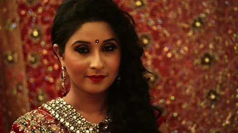 Shot of a smiling Indian bride doing make-up Stock Footage 30081085