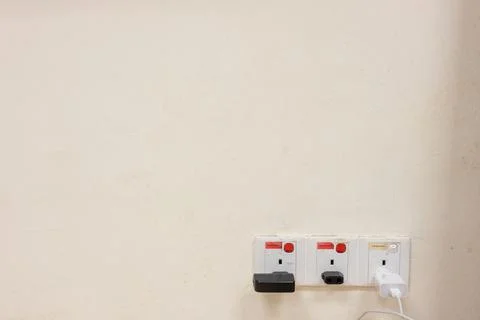 Shot of socket plug on the wall Stock Photos