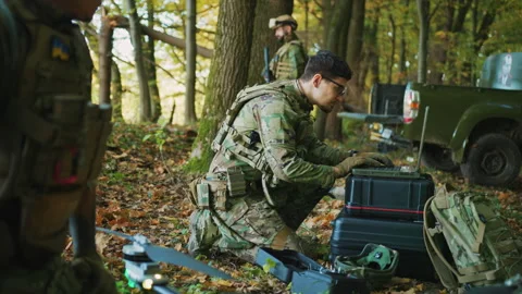 Shot of soldiers using laptop computer for surveillance during a military Video stock 241012332
