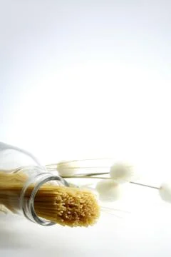 A shot of some spaghetti inserted into a bottle Stock Photos