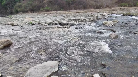 Shot of stream of water. Beautiful view of flowing river water Aswani Khad. Stock Footage 302662670
