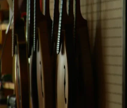 Shot of stringed instruments hanging on the wall Stock Footage 21592935