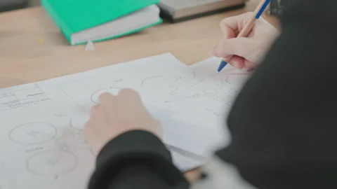 Shot of student projecting drone, drawing quadcopter prototype at work. First Stock Footage 194403067