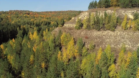 A shot of a summer mountain landscape with trees and a city in the background. Stock Footage 128697406
