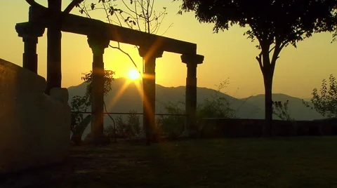 Shot of Sun setting with Stone Pillars in Foreground Stock Footage 52820902