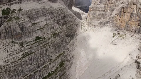 Shot of sunny dolomite limestone rocks with remains of glacier Stock Footage 224541538