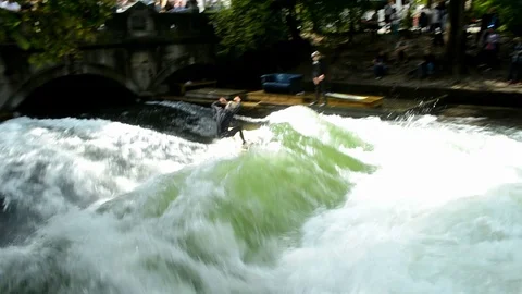 Shot of surfer surfing in Eisbach River in Munich Stock Footage 70816983