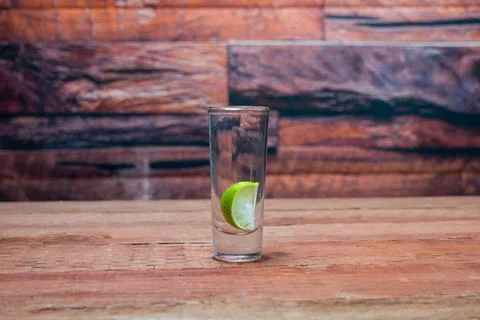 Shot of tequila with a lemon slice inside in a Mexican bar Photos