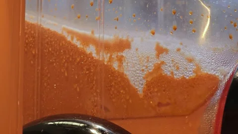 A shot of a Thai tea slurpee machine mixing. Stock Footage 306994554